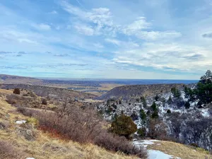 View above the Denver foothills and a snowy hillside