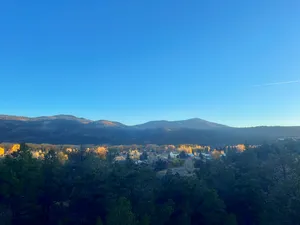 Scenic overview of trees, hills, and the small town of South Fork, Colorado