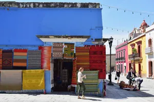 Colorful rugs on display at a shop corner